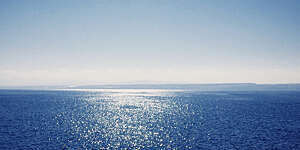 Sparkling sea under a clear blue sky.